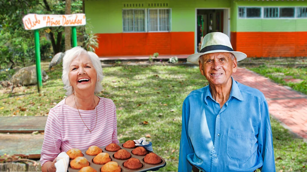 Mujer de la tercera edad sonriendo con bandeja de panes horneados y al lado hombre de la tercera edad contento